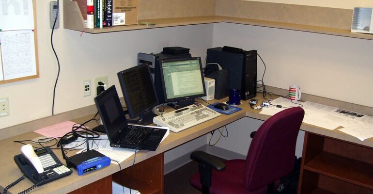 Business office desk representing connected software systems used in CRM integration