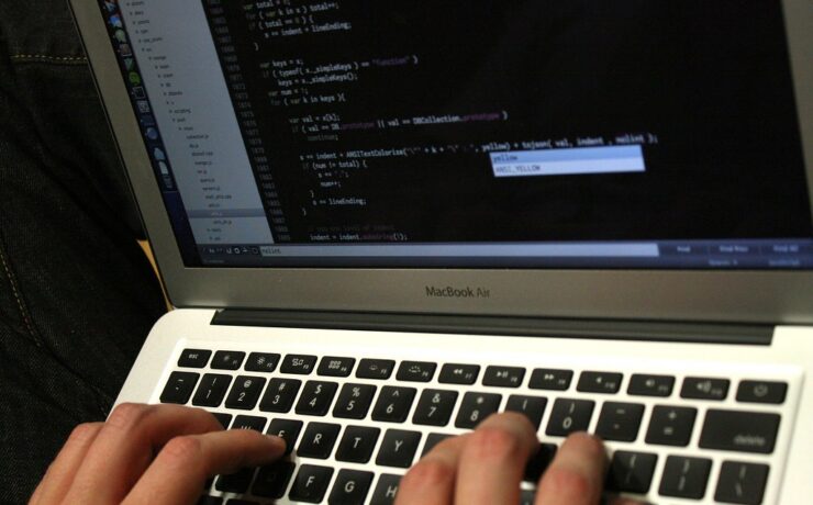 Developer writing code that powers an API system connecting two applications