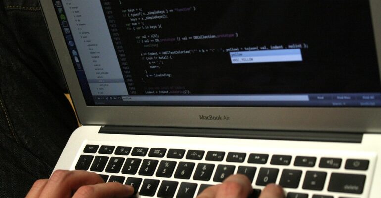 Developer writing code that powers an API system connecting two applications