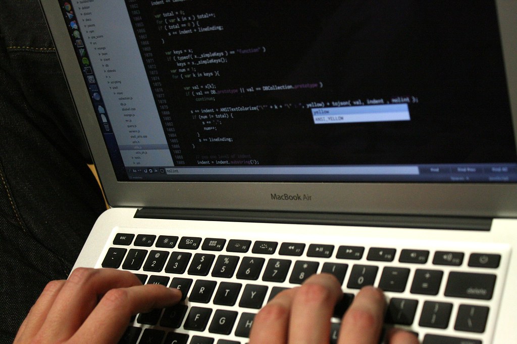 Developer writing code that powers an API system connecting two applications